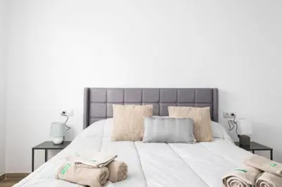 a bedroom with a large white bed with two pillows at Origen Tepoztlán Relájate en un lugar encantador in Torrent