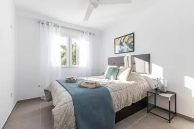 a bedroom with a large bed with a blue blanket at Villamadero Tu refugio de tranquilidad y confort in Torrent