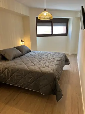 a small bedroom with a bed and a desk at Lorenzo in Benaguacil
