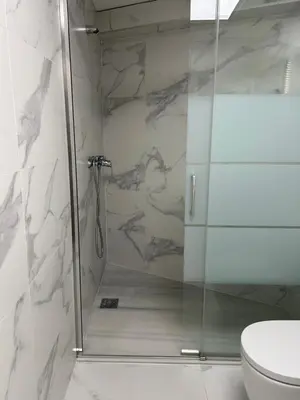 a shower with a glass door in a bathroom at Lorenzo in Benaguacil