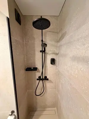 a shower with a shower head in a bathroom at Sunny Waves Apartment in Cullera