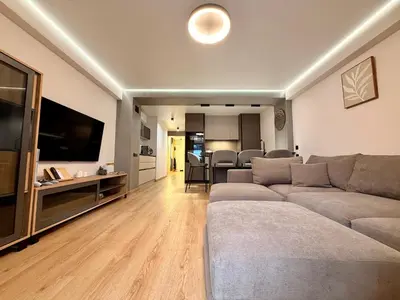 a living room with a couch and a flat screen tv at Sunny Waves Apartment in Cullera