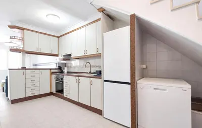 a kitchen with white cabinets and a sink at 4 Bedroom Stunning Home In Sueca in Sueca