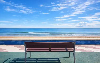 a bench sitting in front of the ocean at 4 Bedroom Stunning Home In Sueca in Sueca