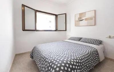 a white bedroom with a bed and a window at 4 Bedroom Stunning Home In Sueca in Sueca