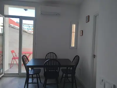 a dining room with a black table and chairs at La Corona de Valencia in Valencia