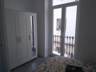 a bedroom with a bed and a large window at La Corona de Valencia in Valencia