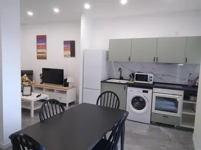 a kitchen with a table and a stove and a microwave at La Corona de Valencia in Valencia