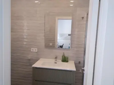 a bathroom with a sink and a mirror at La Corona de Valencia in Valencia