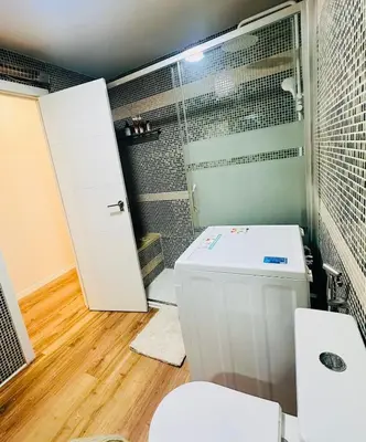 a bedroom with a large white bed with a light at Stylish Bright Centrally Located Home El Botanic in Valencia