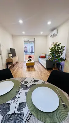 a living room with two tables and a couch at Stylish Bright Centrally Located Home El Botanic in Valencia