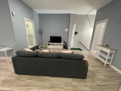 a living room with a couch and a television at Cabañal Flat, Wi-Fi & AACC in Valencia