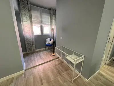 an empty room with a table and a window at Cabañal Flat, Wi-Fi & AACC in Valencia