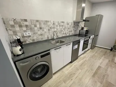 a kitchen with a sink and a washing machine at Cabañal Flat, Wi-Fi & AACC in Valencia