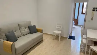 a living room with a couch and a table at Cabanyal Apartment in Valencia