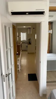 a hallway with a room with a bed and a kitchen at Cabanyal Apartment in Valencia