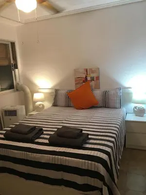 a bedroom with a bed with two pillows on it at Charming beachfront apartment in Puerto de Sagunto