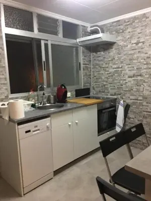 a kitchen with a sink and a stove at Charming beachfront apartment in Puerto de Sagunto