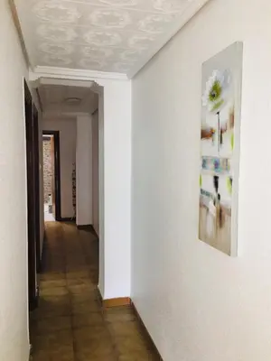 a hallway with a painting on a white wall at Charming beachfront apartment in Puerto de Sagunto