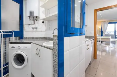 a kitchen with a washing machine and a sink at Patacona Azud in Valencia
