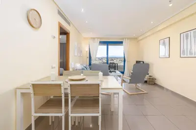 a kitchen and dining room with a table and chairs at Patacona Azud in Valencia
