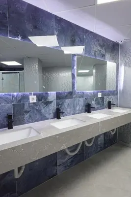 a bathroom with three sinks and a mirror at Joaquin Sorolla Pod Hostel in Valencia