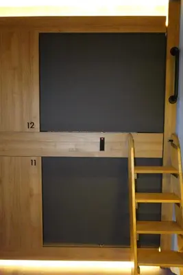 a tv on top of a bunk bed with a ladder at Joaquin Sorolla Pod Hostel in Valencia