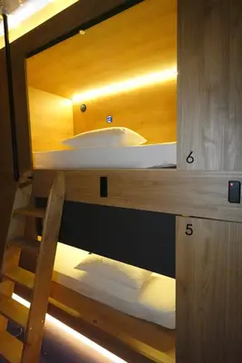 a bedroom with a bunk bed with a mirror at Joaquin Sorolla Pod Hostel in Valencia