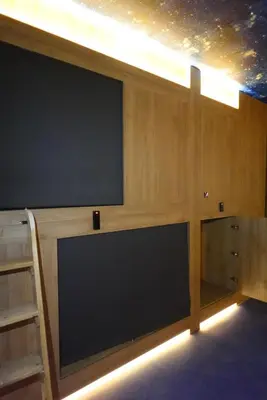 a large flat screen tv sitting on top of a wall at Joaquin Sorolla Pod Hostel in Valencia