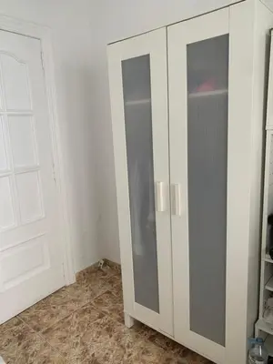 a white cabinet with a door in a room at Habitacion individual cerca del puerto in Valencia