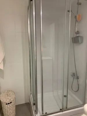 a shower with a glass door in a bathroom at Habitacion individual cerca del puerto in Valencia