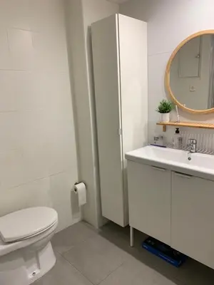 a bathroom with a toilet and a sink and a mirror at Habitacion individual cerca del puerto in Valencia