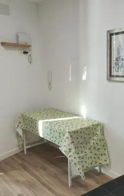 a table with a blanket on it in a room at Studio with garden views in Valencia