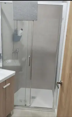 a shower with a glass door in a bathroom at Studio with garden views in Valencia