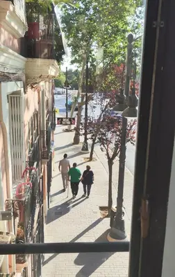 a group of people walking down a street at Studio with garden views in Valencia