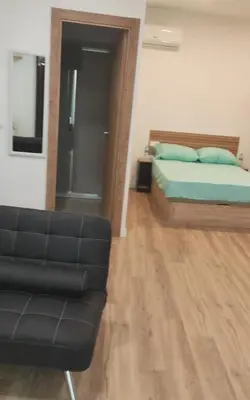 a living room with a bed and a couch at Studio with garden views in Valencia