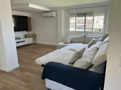 a living room with a couch and a television at Villa Noelia in Turís