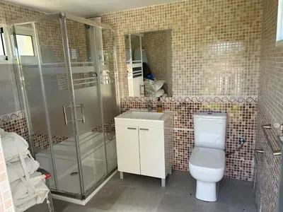 a bathroom with a toilet and a shower and a sink at Villa Noelia in Turís