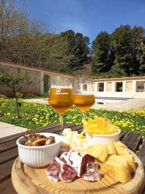 two glasses of beer and cheese and food on a table at La Llar del Magraner in Barraca de Aguas Vivas