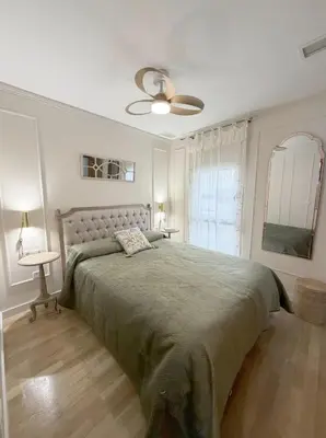 a bedroom with a large bed and a ceiling fan at Nuevo, centrico y luminoso Apartamento casaslacambra in Valencia