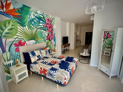 a bedroom with a bed and a mural at Glamour Suite1 next to Plaza de España in Valencia