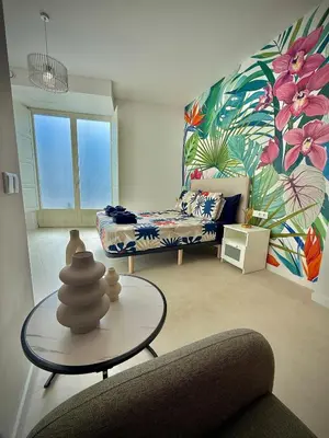a living room with a couch and a table at Glamour Suite1 next to Plaza de España in Valencia