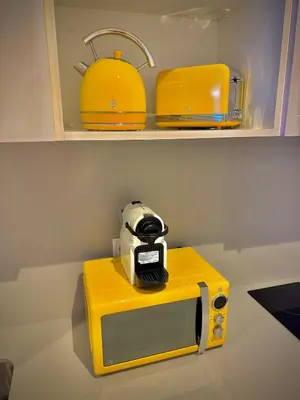 a camera on top of a yellow microwave at Glamour Suite1 next to Plaza de España in Valencia