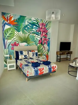 a living room with a couch and a colorful mural at Glamour Suite1 next to Plaza de España in Valencia