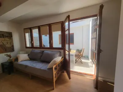 a living room with a couch and a large window at Casa ALFANG in Torrent