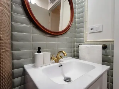 a bathroom with a sink and a mirror at Casa ALFANG in Torrent