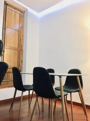 a table and chairs in a room with a door at Historic city center in Valencia
