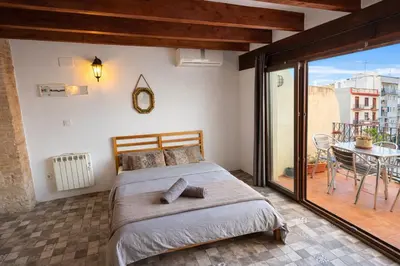 a bedroom with a bed and a brick wall at Kiwi Penthouses in Valencia