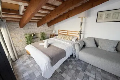 a bedroom with two beds in a brick wall at Kiwi Penthouses in Valencia