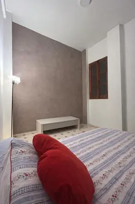 a bedroom with a large red pillow on a bed at Alquiler Hab Centro Valencia in Valencia